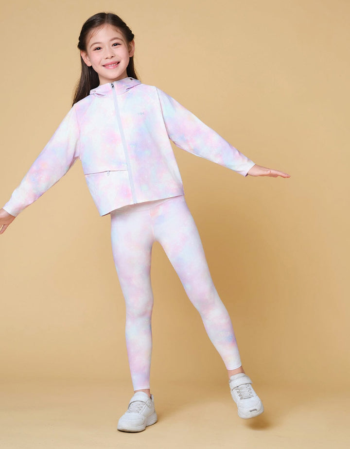 A little girl is wearing a galaxy print Kids Medium Waist UV Protection Cool Touch Ankle Leggings from Her own words SPORTS 